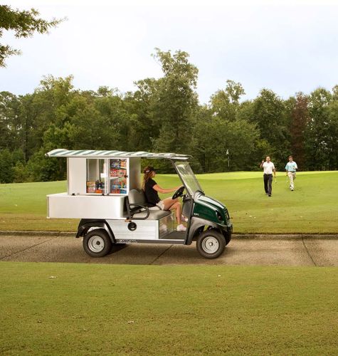 Picture of beverage cart on golf course with salesperson and two golfers